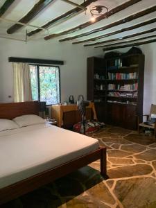 1 dormitorio con cama y estante para libros en Villascape Malindi Entire Villa en Malindi