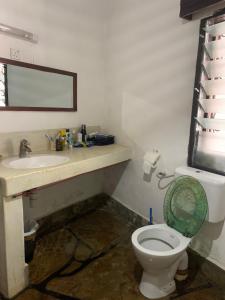 a bathroom with a toilet and a sink at Villascape Malindi Entire Villa in Malindi