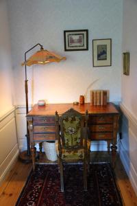 an office with a desk and a chair and an umbrella at Långbro Gård i Mölnbo in Mölnbo