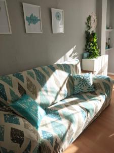 sala de estar con sofá y almohadas en TURQUESA CENTRO, en Soria