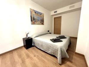 a bedroom with a bed with two pillows on it at La Merced - Más que apartamentos in Murcia
