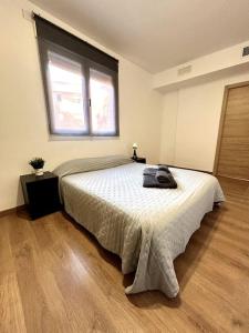 a bedroom with a large bed with a window at La Merced - Más que apartamentos in Murcia