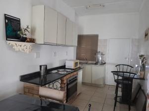 a kitchen with a stove and a counter top at Scenic Guesthouse in Hibberdene