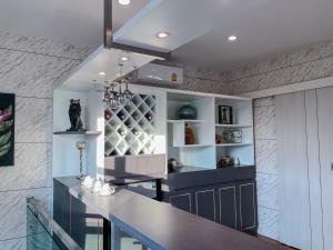 a kitchen with a counter top and a shelf at NanaH Tha Phae Private House in Chiang Mai
