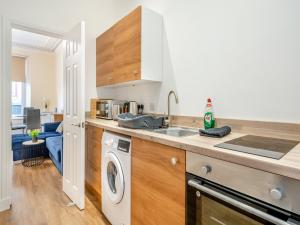 a kitchen with a sink and a washing machine at Apartment Two - Uk44285 in Arbroath