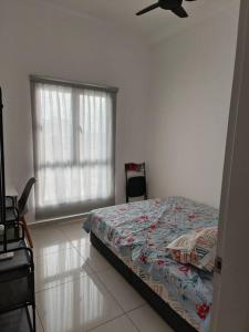 a bedroom with a bed and a window with a ceiling fan at The horizon at Ipoh Entire Apartment in Ipoh +8 photos
