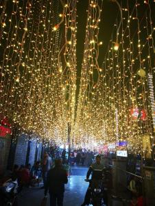 a bunch of lights hanging over a street at night at The Lodge B&B in Jaipur