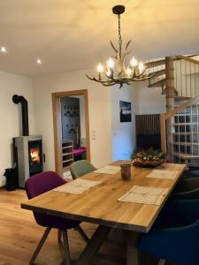 a dining room with a wooden table and a chandelier at Bio Schartenhof in Sankt Johann im Pongau