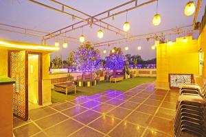 a patio with chairs and lights on a building at JRD Luxury-Business Hotel in New Delhi