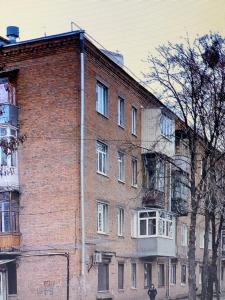 a large brick building on the side of a street at Kholodnaya gora in Kharkiv