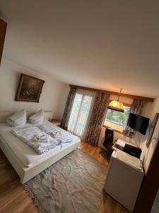 a bedroom with a white bed and a window at Austrian Motel Heiss in Prutz