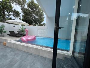 a swimming pool with a pink swan in a house at Ninh Binh Truong Nhan homestay in Ninh Binh