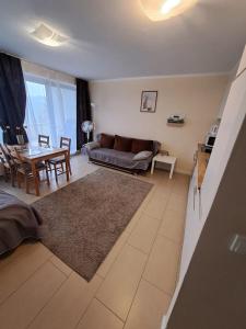 a living room with a couch and a table at Apartament Wisła Bukowa in Wisła