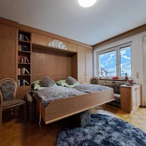 a bedroom with a bed and a large window at Studio-Appartement Drei Hörndl in Bad Hofgastein