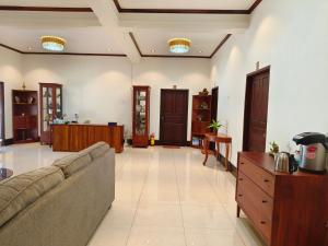 a living room with a couch and a table at ksana guesthouse in Luang Prabang