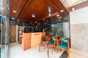 a dining room with two chairs and a table at Treebo Bright Plaza & Spa in Mahabaleshwar
