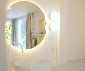 a bathroom with a white sink and a mirror at Sawasdee Coco in Ko Samed