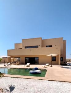 a house with a swimming pool in front of it at Marrakech Luxury Villa 