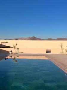 a swimming pool in the middle of the desert at Marrakech Luxury Villa 