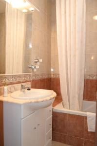 a bathroom with a sink and a shower curtain at Pension Canadiense in Barcelona