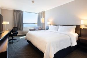 a hotel room with a large bed and a desk at Holiday Inn Express - Antofagasta, an IHG Hotel in Antofagasta