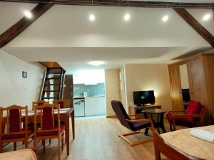 a living room with a table and chairs and a kitchen at Krakow Old Town Apartment in Krakow