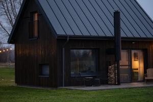 a wooden house with a gambrel roof at Daczowisko in Gruczno