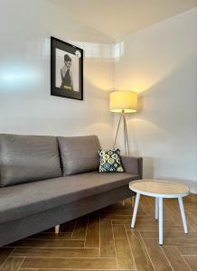 a living room with a couch and a table at Apartament Ula in Nysa