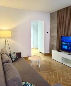 a living room with a couch and a tv at Apartament Ula in Nysa