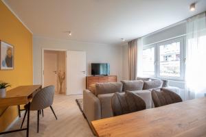 a living room with a couch and a table at Innenstadt-Apartments Klinik Friedrichstadt in Dresden