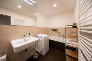 ein Badezimmer mit einem Waschbecken und einer Badewanne in der Unterkunft Innenstadt-Apartments Klinik Friedrichstadt in Dresden