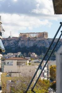 a view of a building on top of a mountain at 4 Family and Friends - Acropolis view in Athens