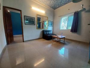 a living room with a couch and a table at ECO tree inn Villa in Kottakupam