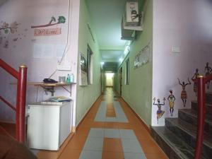 a corridor of a building with a long hallway at ECO tree inn Villa in Kottakupam