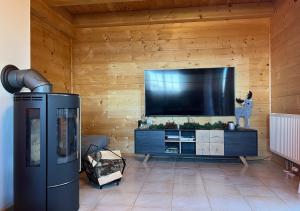 a living room with a large flat screen tv at 1A Chalet Koralpe - im Ski Gebiet - Sauna und Wellness in Hartelsberg