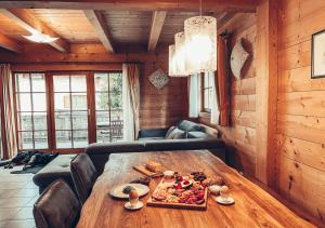 a room with a wooden table with food on it at 1A Chalet Koralpe - im Ski Gebiet - Sauna und Wellness in Hartelsberg