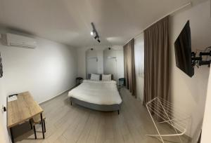 a bedroom with a bed in the middle of a room at City Centre One in Skopje