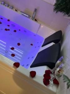 a table with hearts on it with a purple ceiling at Spa jacuzzi Caen centre in Caen