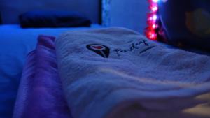 a blanket on a bed in a room with a christmas tree at The Rendezvous Hostel in Haad Rin