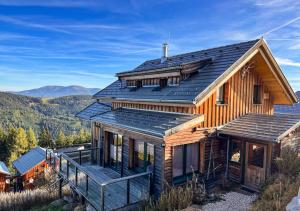 a wooden house with a metal roof at 1A Chalet "Wolke" Ski und Wellness im Traumhaus in Wolfsberg