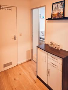 a room with a counter and a door and a room with a door at Weideglück-Zentral-Dampfdusche in Oberstaufen +8 photos