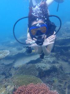 a woman in a diving suit and goggles underwater at Con Dao Backpacker - LoCo Camping in Con Dao