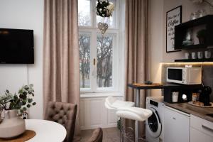 a living room with a table and a window at Apartment HYGGE in Subotica