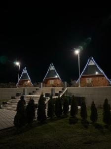 a row of houses at night with lights at Bungalow Damiano's in Mrkonjić Grad