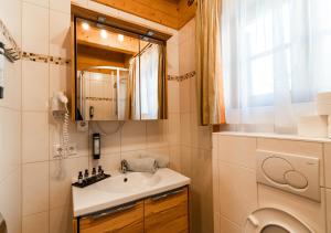 a bathroom with a sink and a washing machine at 1A Chalet Koralpe Wandern, Grillen mit Sauna und Wellness in Hartelsberg +64 photos