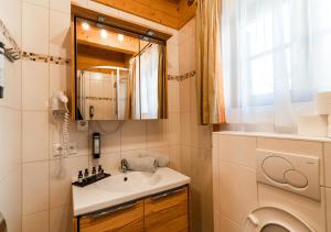 a bathroom with a sink and a washing machine at 1A Chalet Koralpe - im Ski Gebiet - Sauna und Wellness in Hartelsberg