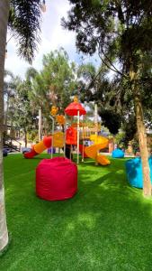 a playground with a colorful play equipment in a park at La Berza Resort in Subang