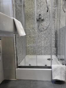 a bathroom with a shower with a white tub at Mek lux Bjelasnica in Bjelašnica