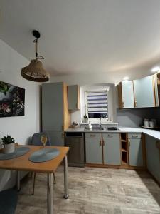 a small kitchen with a table and a sink at Apartament nad rzeką in Kowary