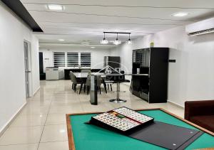 a living room with a table with a keyboard on it at 3BR Single Storey PD - 8Pax in Port Dickson